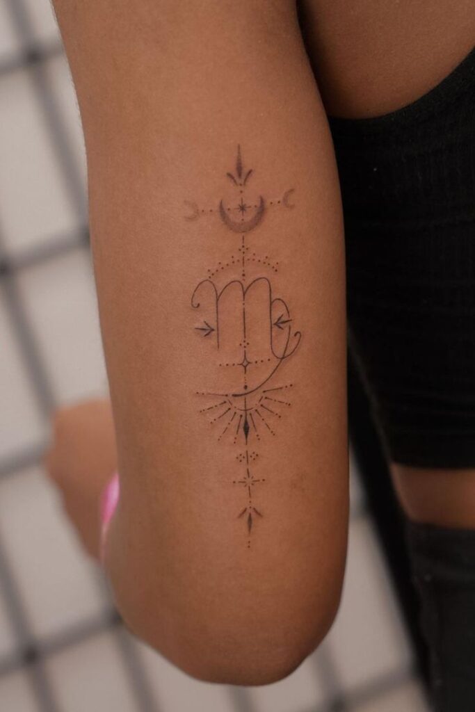 Delicate Scorpio zodiac tattoo on arm, featuring intricate linework and celestial designs in a minimalist style.