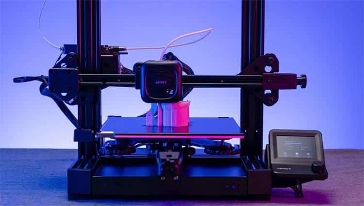 FDM-3D-printing-of-HPRT-F210 Modern 3D printer with LCD screen and filament spool on blue background. | Sky Rye Design Modern 3D printer with LCD screen and filament spool on blue background.