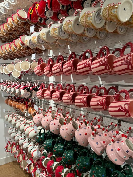 For more inspo pics 𝓹𝓲𝓷_ 𝓮𝓵𝓬𝓱𝓸𝓬𝓸𝓵𝓪𝓽𝓮𝓰𝓲𝓻𝓵 🤎 Colorful festive mugs displayed on shelves, featuring various holiday designs like stripes and patterns. Perfect for seasonal gifting. | Sky Rye Design Colorful festive mugs displayed on shelves, featuring various holiday designs like stripes and patterns. Perfect for seasonal gifting.