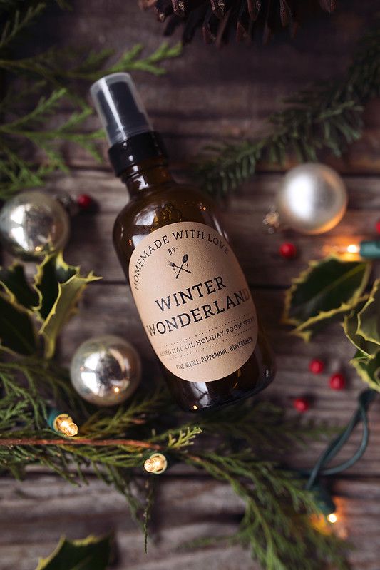 How-to Make Essential Oil Holiday Room Sprays Bottle of Winter Wonderland essential oil room spray surrounded by festive greenery and ornaments, perfect for holiday ambiance. | Sky Rye Design Bottle of Winter Wonderland essential oil room spray surrounded by festive greenery and ornaments, perfect for holiday ambiance.