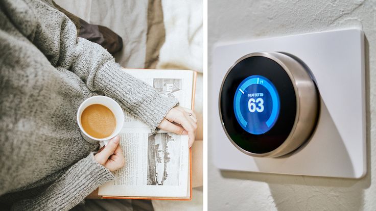 Person reading with a coffee mug beside a smart thermostat set to 63 degrees, showcasing cozy home atmosphere and tech comfort.