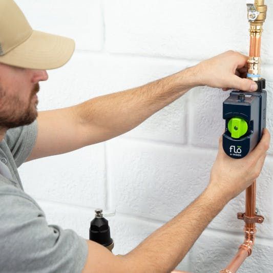Meet Flo Smart Water Shut Off _ Smart Water Monitor _ Moen Plumber installs smart water monitor device on copper pipe to detect leaks and conserve water. | Sky Rye Design Plumber installs smart water monitor device on copper pipe to detect leaks and conserve water.