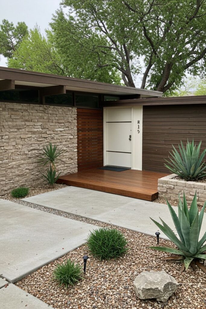 Midcentury Modern Landscaping Ideas That Instantly Boost Curb Appeal Modern mid-century entrance with minimalist landscaping, stone walls, and wooden accents surrounded by greenery and succulents. | Sky Rye Design Modern mid-century entrance with minimalist landscaping, stone walls, and wooden accents surrounded by greenery and succulents.