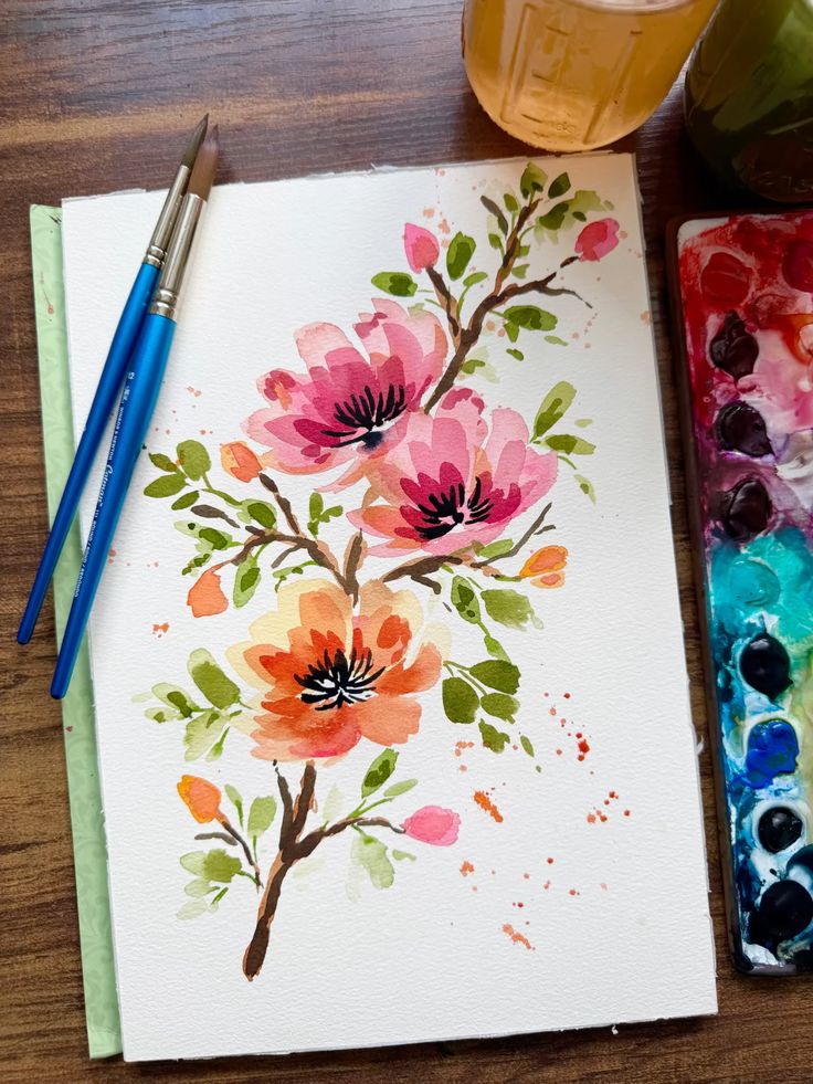 My five tips to instantly loosen up your watercolor florals Watercolor painting of vibrant flowers with paintbrushes and palette on a wooden table, perfect for artistic inspiration and creativity. | Sky Rye Design Watercolor painting of vibrant flowers with paintbrushes and palette on a wooden table, perfect for artistic inspiration and creativity.