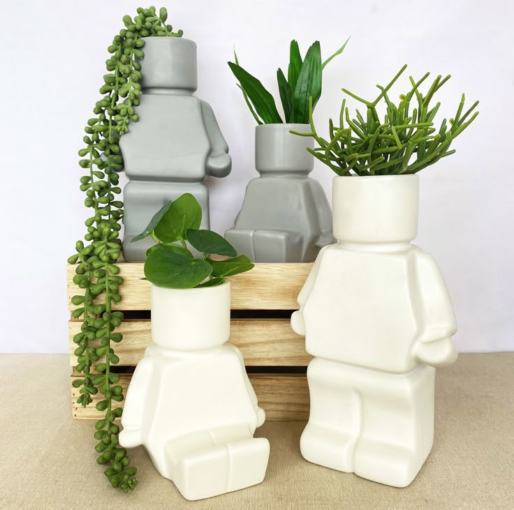 Our Block Man Planters now have a little friend The sitting version will be ARRIVING SOON 💕 🏷 planters blockmanplanter quirkyplanter houseplants Unique LEGO-style planters with lush green plants, displayed on a wooden crate. Perfect for adding a playful touch to home decor. | Sky Rye Design Unique LEGO-style planters with lush green plants, displayed on a wooden crate. Perfect for adding a playful touch to home decor.