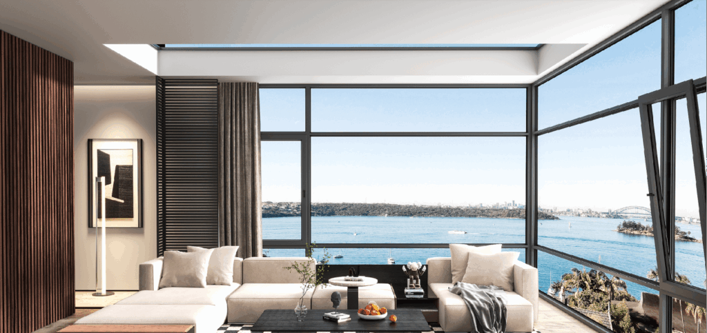 Modern living room overlooking Sydney Harbour with large windows, stylish furniture, and a scenic view of the bridge and water.