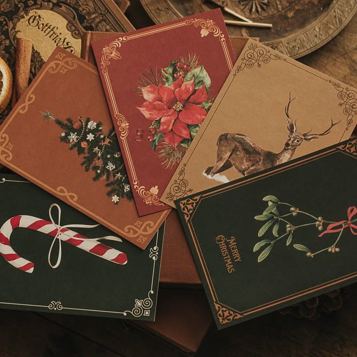 Vintage Christmas cards with festive designs featuring poinsettia, reindeer, candy cane, and mistletoe on a wooden table.