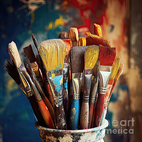 A vibrant collection of colorful paintbrushes in a pot, set against an artistically blurred background, awaiting creative expression.
