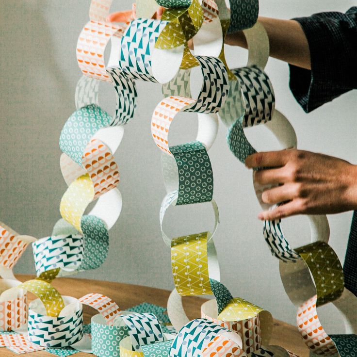 Paper Chain Garland - Rainbow Colorful DIY paper chain decoration being created by hand. | Sky Rye Design Colorful DIY paper chain decoration being created by hand.