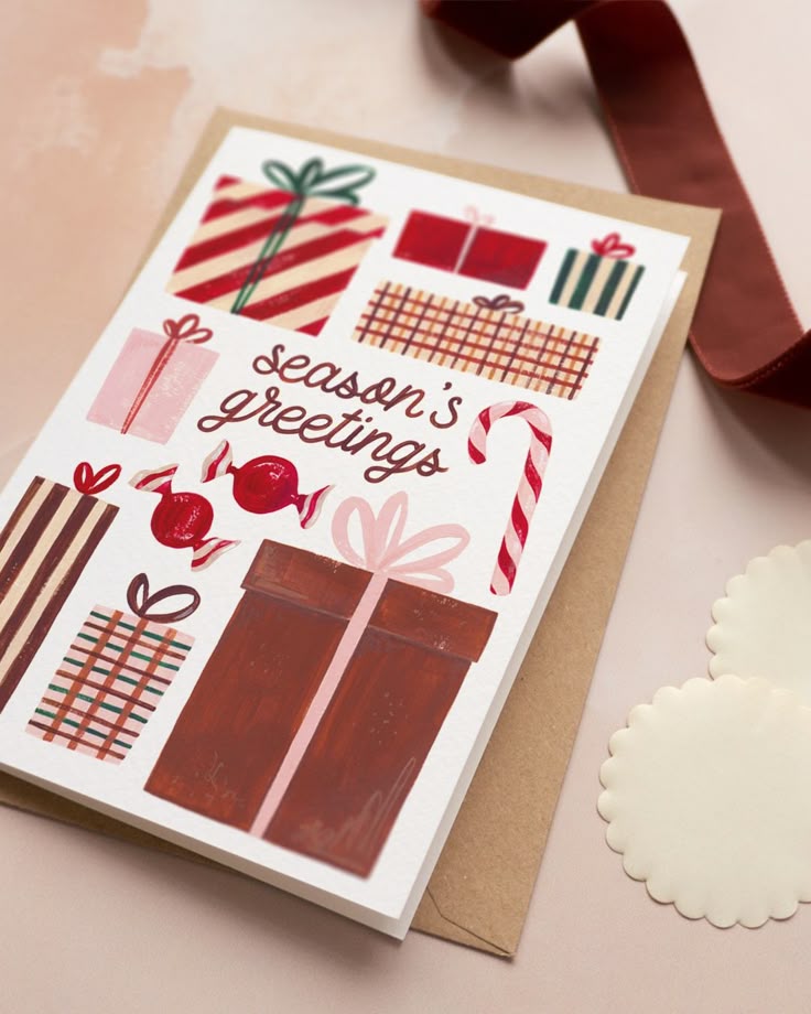 Festive greeting card with colorful gifts, candy canes, and the message Season's Greetings on a white background, perfect for holidays.