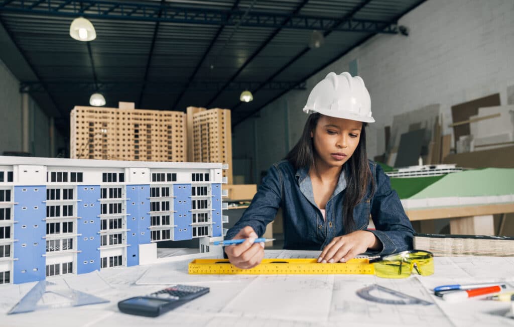 Residential-Estimating-Services-1024x651 Young female architect with hard hat working on building model in design studio. | Sky Rye Design Young female architect with hard hat working on building model in design studio.