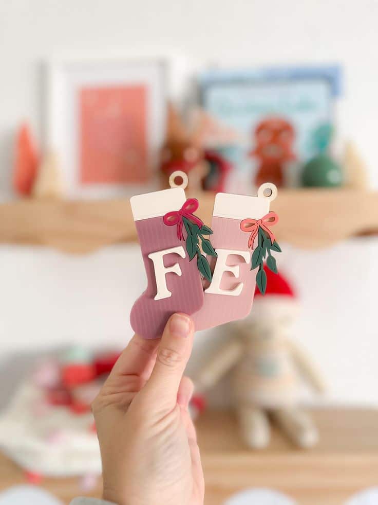 Stocking Tag 3D Stocking Tag Acrylic Name Tag Christmas Ornament Christmas Gift Tag Hand holding two decorative Christmas stockings with F and E in a festive home setting. | Sky Rye Design Hand holding two decorative Christmas stockings with F and E in a festive home setting.
