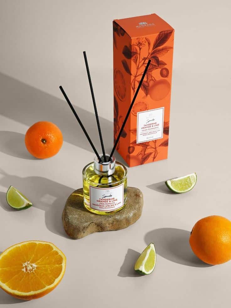 Tangerine Orange Lime Home Fragrance 100 ml Orange and lime scented reed diffuser with decorative box, surrounded by fresh citrus slices, on a neutral background. | Sky Rye Design Orange and lime scented reed diffuser with decorative box, surrounded by fresh citrus slices, on a neutral background.
