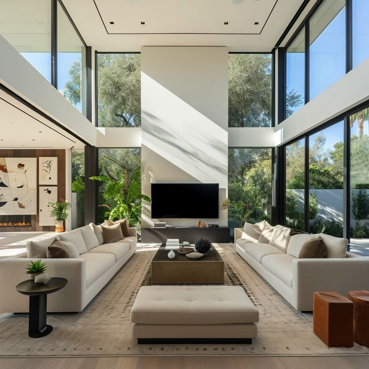 Modern living room with large windows, beige sofas, and greenery, creating a bright, inviting space with a stylish, minimalist design.