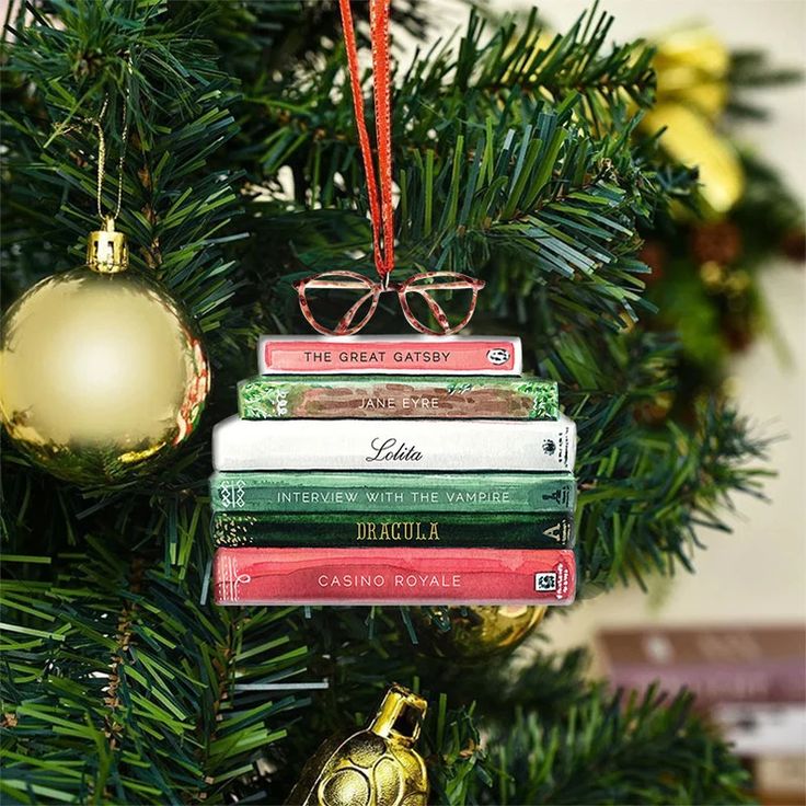 The Best Book Lover Christmas Ornaments - BOOKGLOW Book-themed Christmas tree ornament featuring miniature classics like The Great Gatsby and Dracula, with a golden bauble nearby. | Sky Rye Design Book-themed Christmas tree ornament featuring miniature classics like The Great Gatsby and Dracula, with a golden bauble nearby.