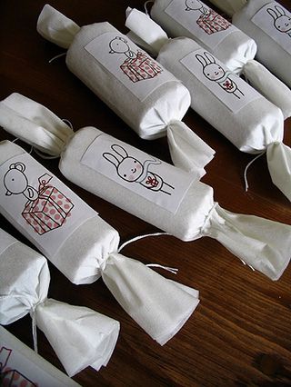 Typepad _ Network Solutions Handmade festive holiday crackers with cute bunny and gift illustrations, neatly arranged on a wooden table for decoration or celebration. | Sky Rye Design Handmade festive holiday crackers with cute bunny and gift illustrations, neatly arranged on a wooden table for decoration or celebration.