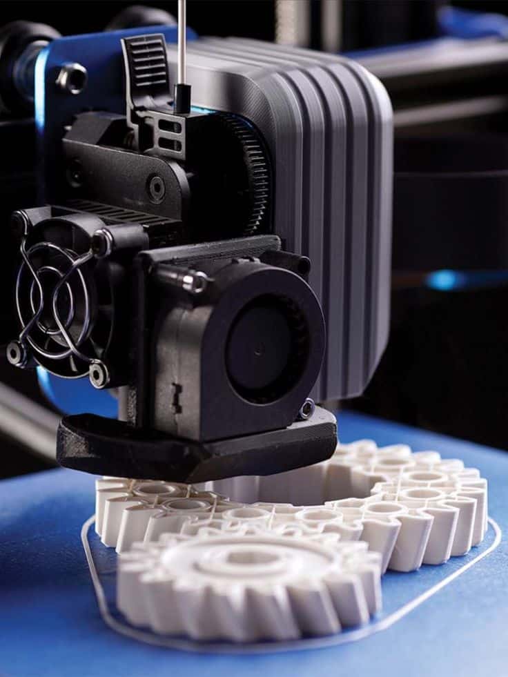 Unleashing the Potential_ Exploring the Power of 3D Scanning and 3D Printing 3D printer creating a detailed white plastic gear on a blue surface, showcasing precision technology and advanced manufacturing techniques. | Sky Rye Design 3D printer creating a detailed white plastic gear on a blue surface, showcasing precision technology and advanced manufacturing techniques.