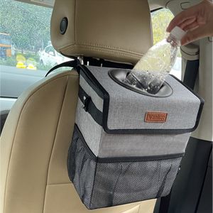 Car seat back trash can in use, with a person placing a plastic bottle inside. Compact and convenient for vehicle organization.
