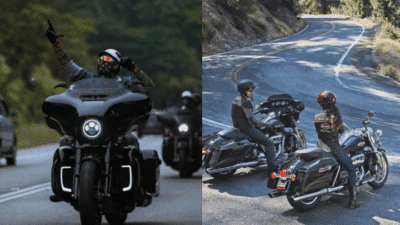Motorcyclists enjoy scenic highway ride; one waves while the others pause, showcasing camaraderie and adventure on a curving road.