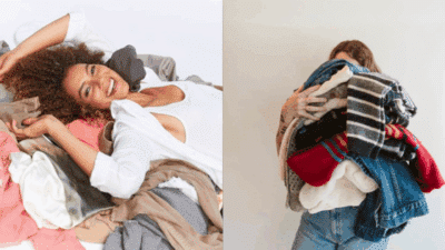 Two women enjoying piles of mixed clothing; one lying down smiling, the other holds a bundle of colorful clothes in front of her.