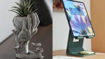 Decorative planter with hand design and tablet on a stylish stand, perfect for a modern home or office setup.