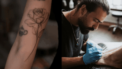 Tattoo artist with beard creating body art; showcases detailed rose tattoo on arm and professional technique.