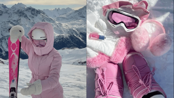 Viewing Deck Blog копия 18 A person in a pink ski outfit holding skis on a snowy mountain with goggles and gloves. | Sky Rye Design A person in a pink ski outfit holding skis on a snowy mountain with goggles and gloves.