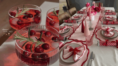 Festive table setup with pink and red decor, featuring cranberry cocktails garnished with rosemary, ready for a New Year celebration.