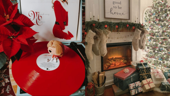 Cozy Christmas scene with red vinyl, poinsettia, and a decorated fireplace with stockings and gifts.