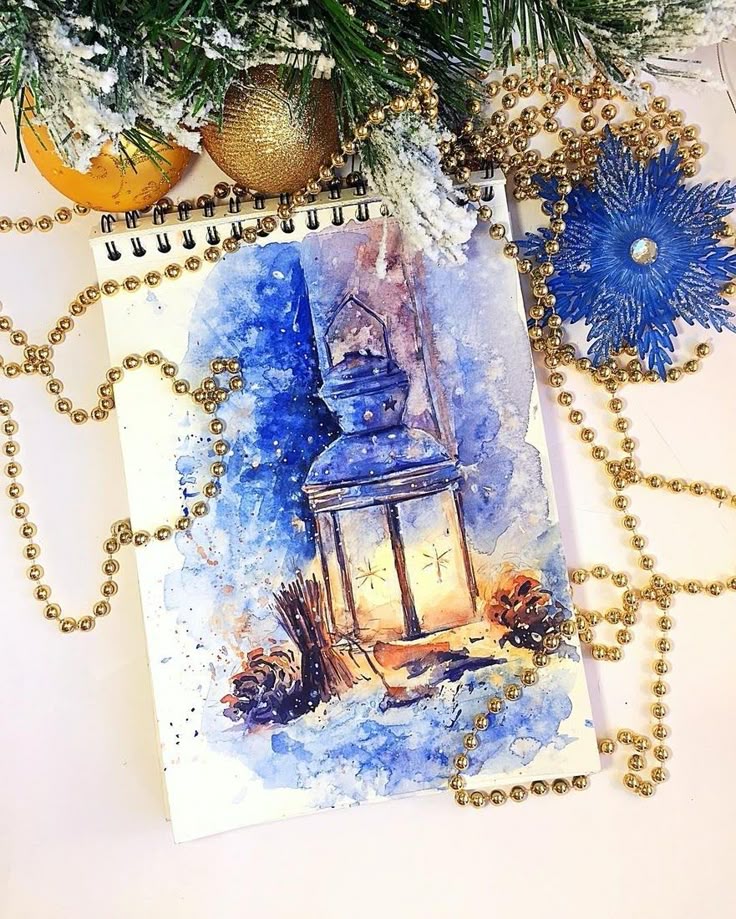 Watercolor painting of a glowing lantern in a winter scene, surrounded by pinecones, festive ornaments, and golden beads.