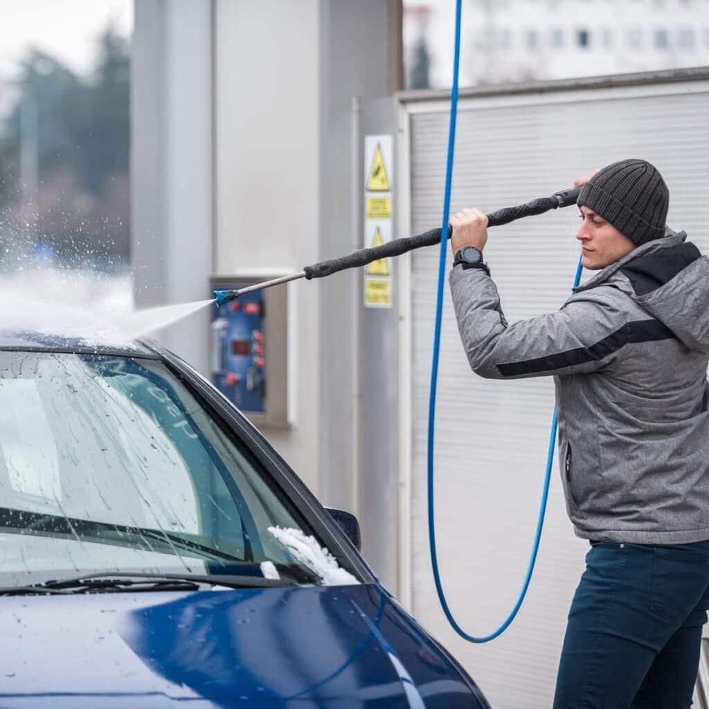 b547d48455d792e3b2e1e71486a79d16 Person pressure washing blue car at outdoor wash station on a cloudy day. Keep your vehicle clean and shiny with effective car cleaning. | Sky Rye Design Person pressure washing blue car at outdoor wash station on a cloudy day. Keep your vehicle clean and shiny with effective car cleaning.