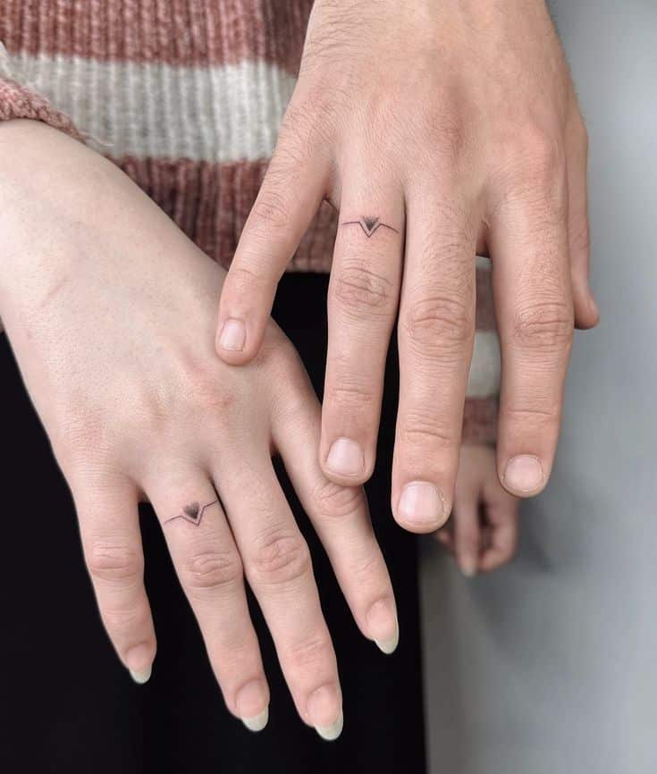 b8343368865d8b21ad2184d70888cc60 Couple with matching finger tattoos, minimalist heart and triangle designs on ring fingers. | Sky Rye Design Couple with matching finger tattoos, minimalist heart and triangle designs on ring fingers.