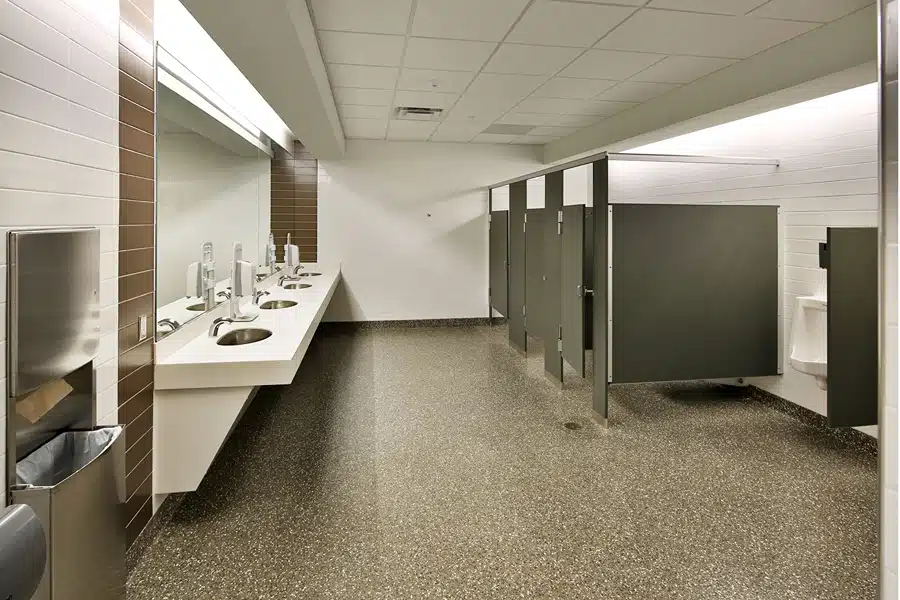 bathroom-stall-repair-main Modern public restroom with multiple sinks, mirrors, and stalls, featuring a clean and spacious layout. | Sky Rye Design Modern public restroom with multiple sinks, mirrors, and stalls, featuring a clean and spacious layout.