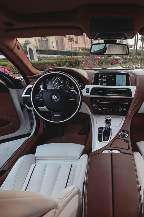 Luxury BMW car interior featuring modern dashboard, leather seats, and advanced technology for a premium driving experience.