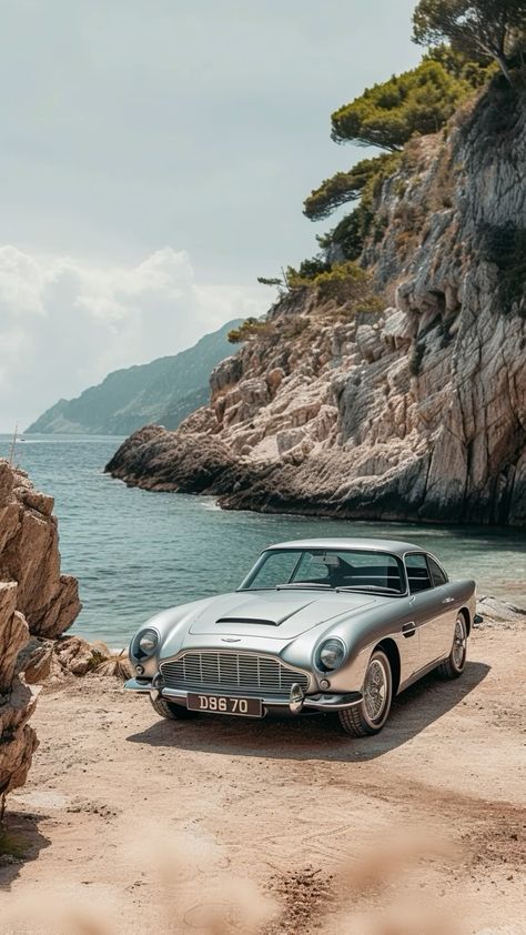 c2dce93fe0e45585d8909e115edb875d Classic silver car parked on a scenic coastal road beside rocky cliffs and turquoise sea under a cloudy sky. | Sky Rye Design Classic silver car parked on a scenic coastal road beside rocky cliffs and turquoise sea under a cloudy sky.