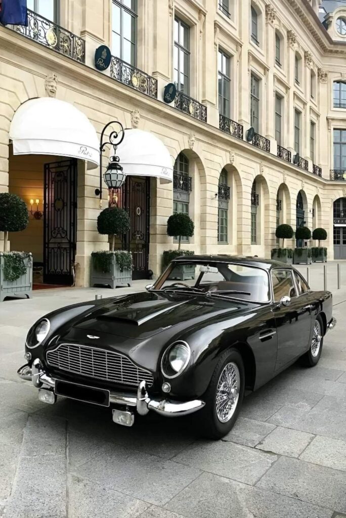 cf87748de609ef9d3fd9b0095a1b2a6b Classic black luxury car parked elegantly outside a historic building with ornate balconies and arched windows. | Sky Rye Design Classic black luxury car parked elegantly outside a historic building with ornate balconies and arched windows.