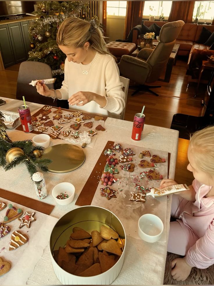christmas aesthetic baking gingerbread Family decorating Christmas cookies at home, surrounded by festive decor and a Christmas tree. | Sky Rye Design Family decorating Christmas cookies at home, surrounded by festive decor and a Christmas tree.