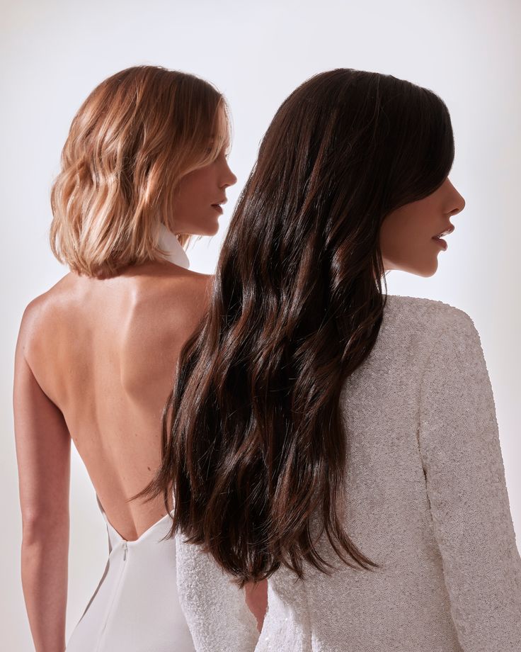 d9619066e6fa0a45c04545b256484382 Two women with elegant hairstyles, brunette with long curls and blonde with a bob, wearing white outfits, side view. | Sky Rye Design Two women with elegant hairstyles, brunette with long curls and blonde with a bob, wearing white outfits, side view.