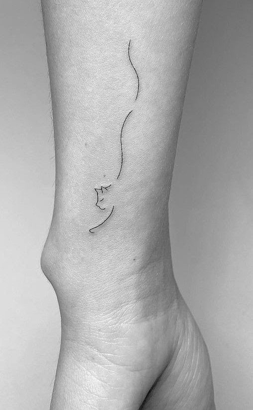 da0de50d8a522eba055bd830f1368aa3 Minimalist line art tattoo of a face on a forearm, showcasing simple and elegant design. | Sky Rye Design Minimalist line art tattoo of a face on a forearm, showcasing simple and elegant design.
