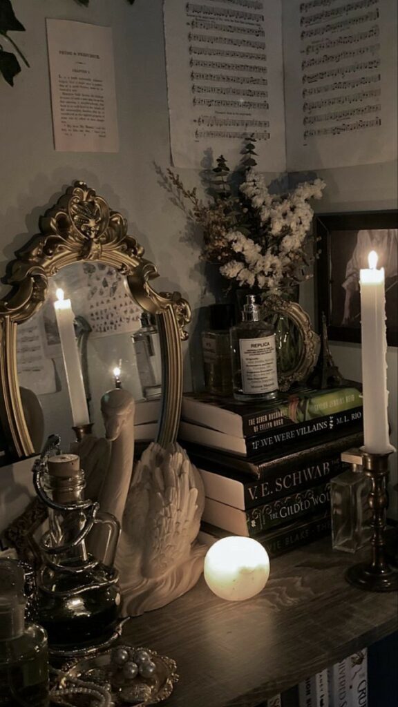 Cozy vintage-themed room with candles, books, decorative mirror, and flowers, creating a warm, inviting atmosphere perfect for relaxation.