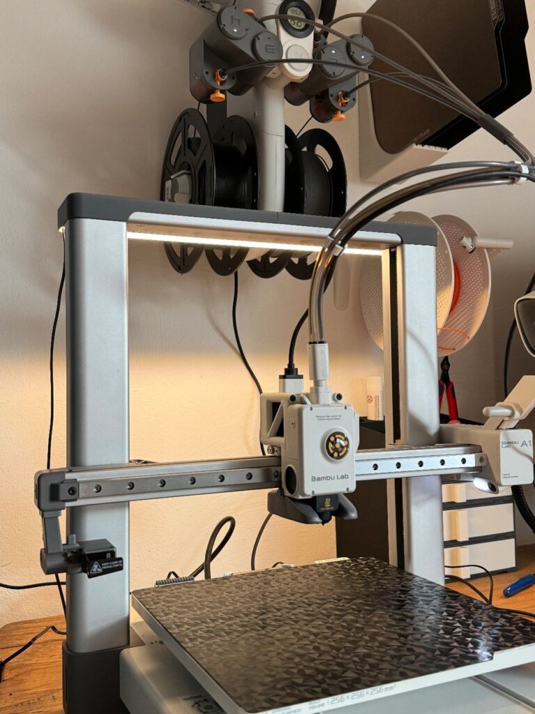 Modern 3D printer setup with spools and precision equipment for advanced printing projects.