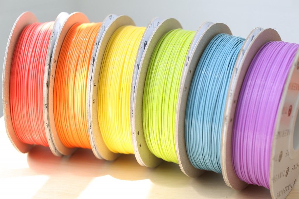 e3ece16a335eb1ec4d14360f75893f39 Colorful 3D printer filament spools in orange, yellow, green, blue, and purple on display in bright sunlight. | Sky Rye Design Colorful 3D printer filament spools in orange, yellow, green, blue, and purple on display in bright sunlight.