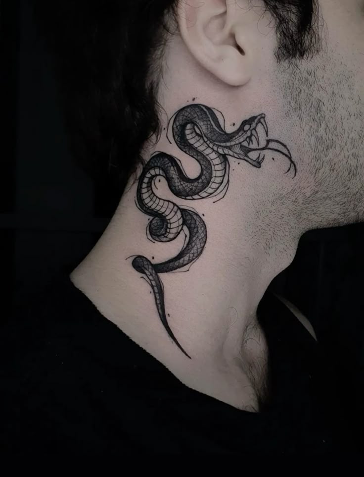 Snake tattoo on the neck, featuring intricate black line work and shading, creating a detailed and dynamic design against a light skin tone.