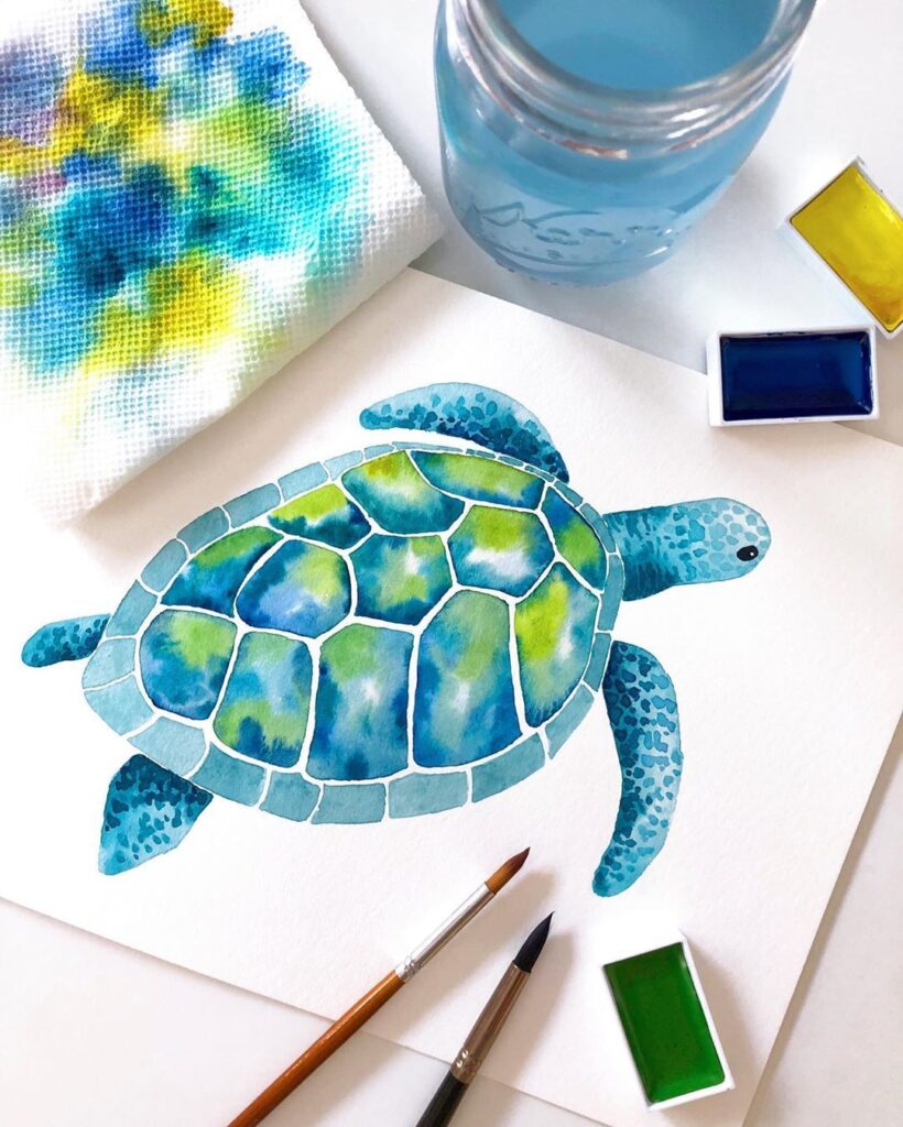 ebf3bb1bac2e9fc82db8c9b48fd058be Watercolor painting of a sea turtle in blues and greens, with art supplies including paintbrushes, water jar, and paints on a table. | Sky Rye Design Watercolor painting of a sea turtle in blues and greens, with art supplies including paintbrushes, water jar, and paints on a table.