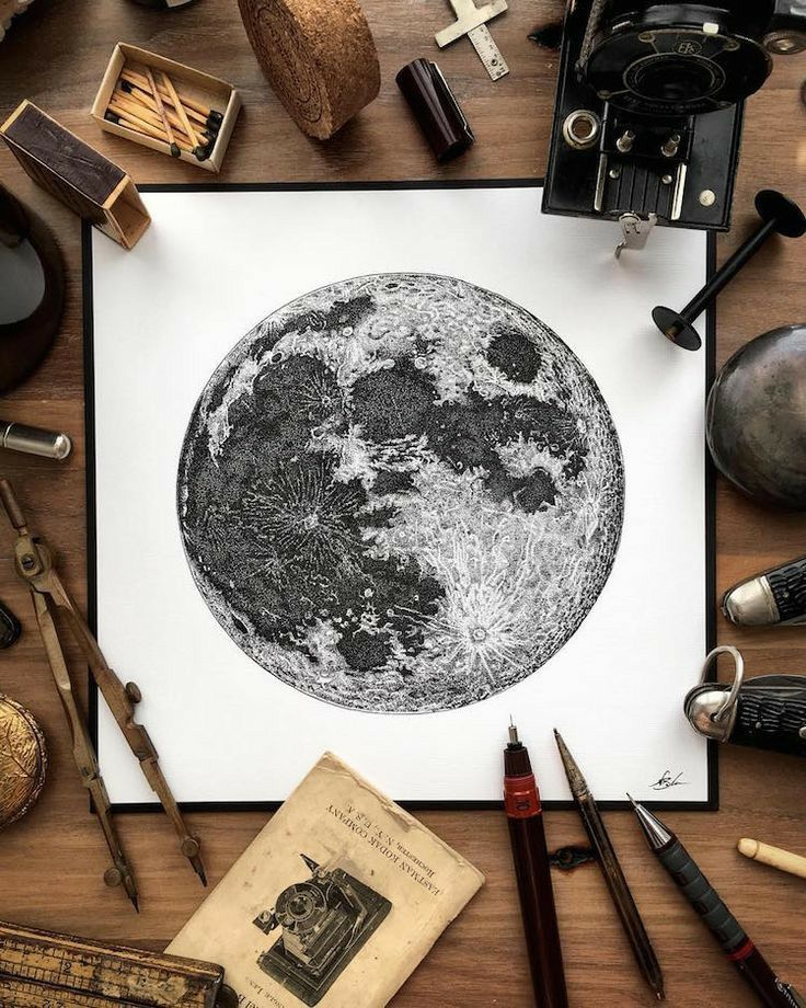 Intricate moon illustration on a wooden desk, surrounded by vintage tools and camera, conveying a vintage astronomy and art theme.