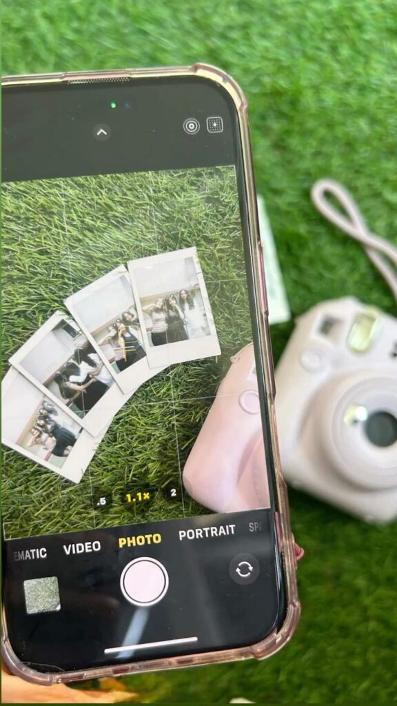 fdbvaS Smartphone capturing Polaroids on grass with instant camera nearby. | Sky Rye Design Smartphone capturing Polaroids on grass with instant camera nearby.
