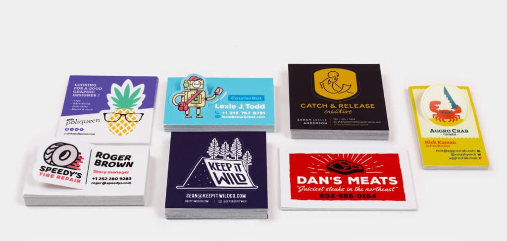 hero Assorted, colorful business cards with unique designs and logos displayed in stacks on a plain background. | Sky Rye Design Assorted, colorful business cards with unique designs and logos displayed in stacks on a plain background.