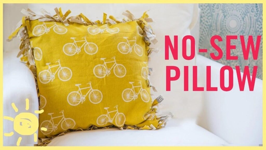 Yellow no-sew pillow with bicycle pattern, placed on a white chair. Perfect DIY home decor project. Easy craft idea for beginners.