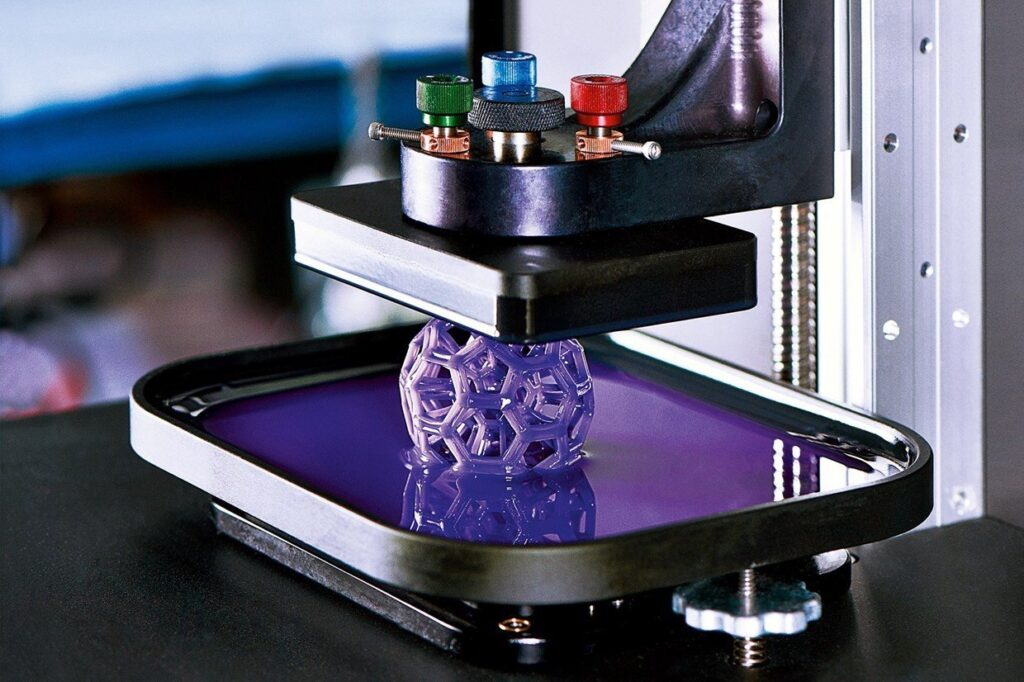 image_11 3D printer creating a complex geometric structure in purple resin. | Sky Rye Design 3D printer creating a complex geometric structure in purple resin.