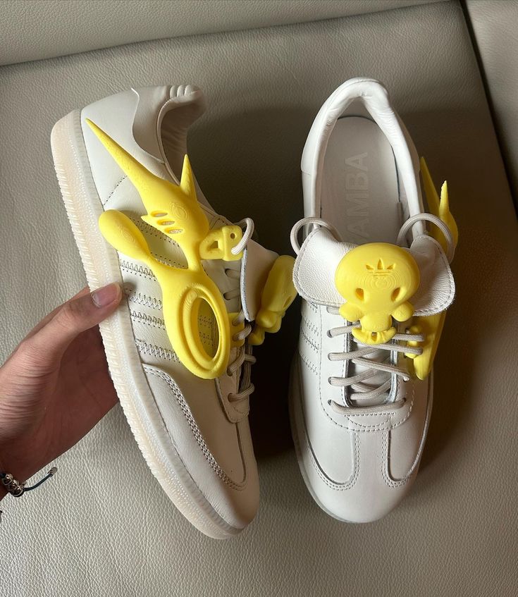 offgod yalocaloffgod Fotos e vídeos do Instagram White sneakers with unique yellow cartoon character accents, held in hand on a beige background. Stylish and playful footwear design. | Sky Rye Design White sneakers with unique yellow cartoon character accents, held in hand on a beige background. Stylish and playful footwear design.
